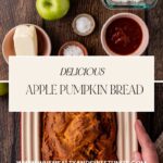 A top view captures a freshly baked loaf of mouthwatering apple pumpkin bread in a pan, enveloped by green apples, butter, flour, and spices on a rustic wooden table. A card reads Delicious Apple Pumpkin Bread with a website link below as hands eagerly grip the pan.