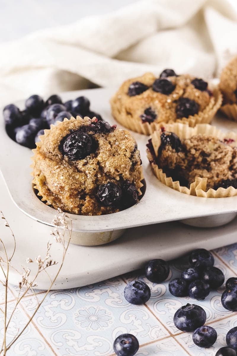 vegan blueberry muffins in a muffin tin