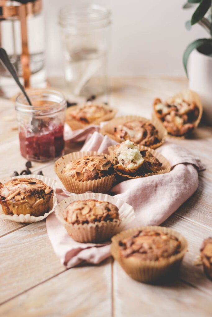 muffins on the table with strawberry jam and a pink napkin