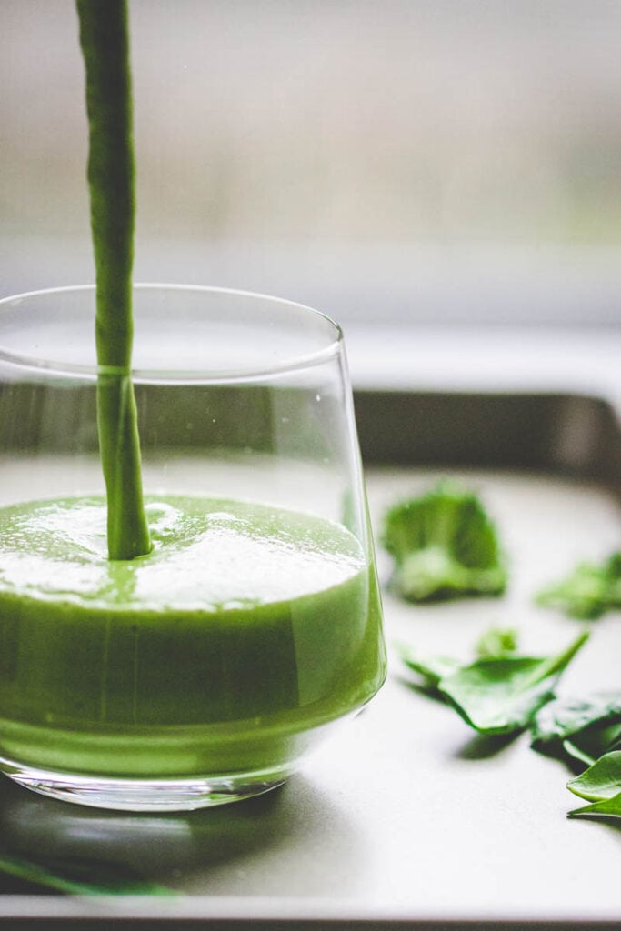 pouring a broccoli smoothie
