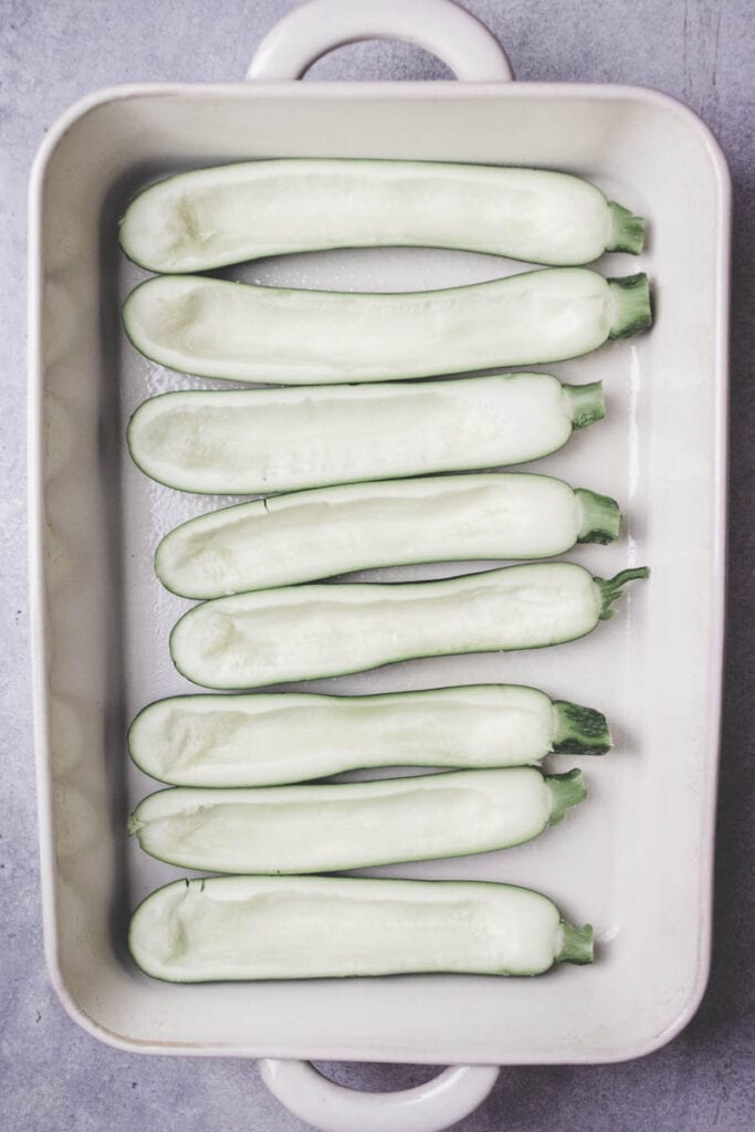 zucchini boats in a baking dish.