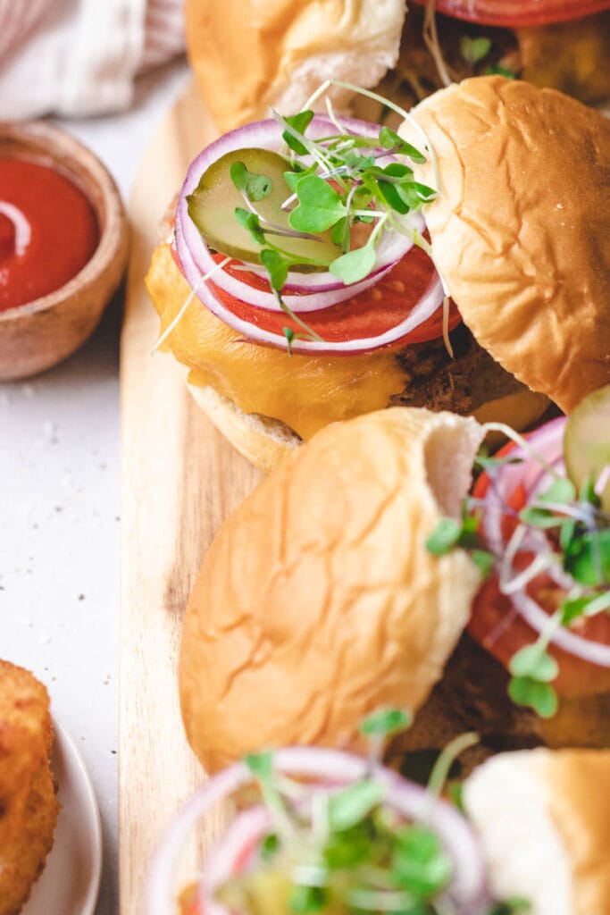 picture of burger fixings: tomato, onion and micro greens