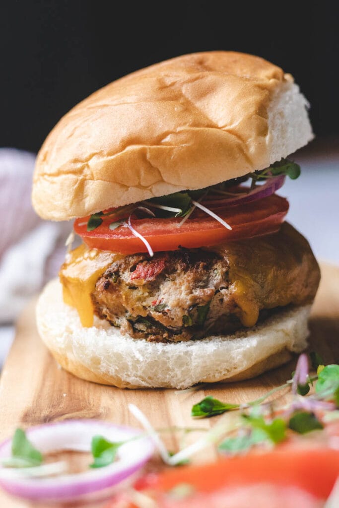 close up of turkey basil burger in a bun 