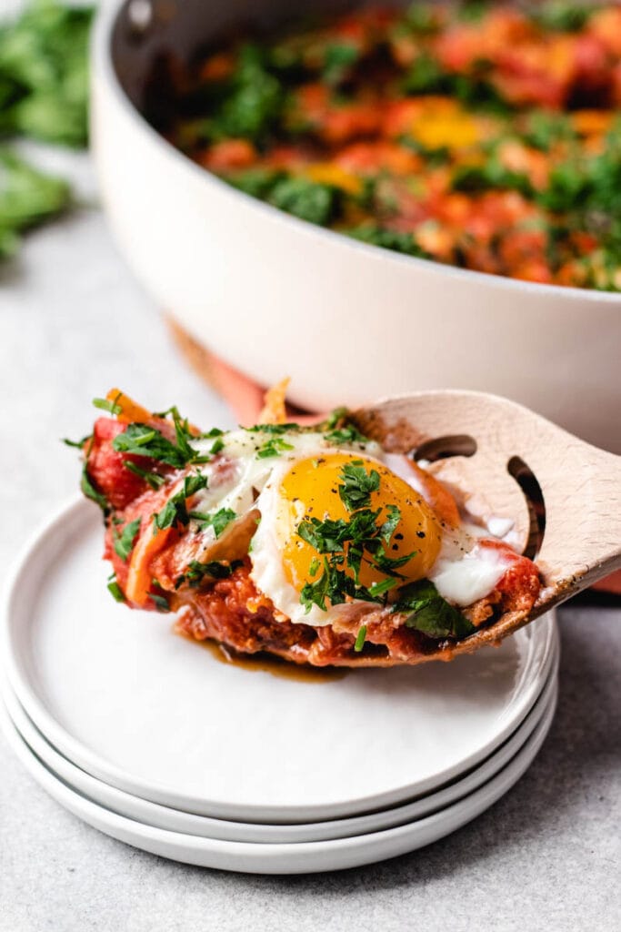 serving shakshuka with chunky tomato sauce