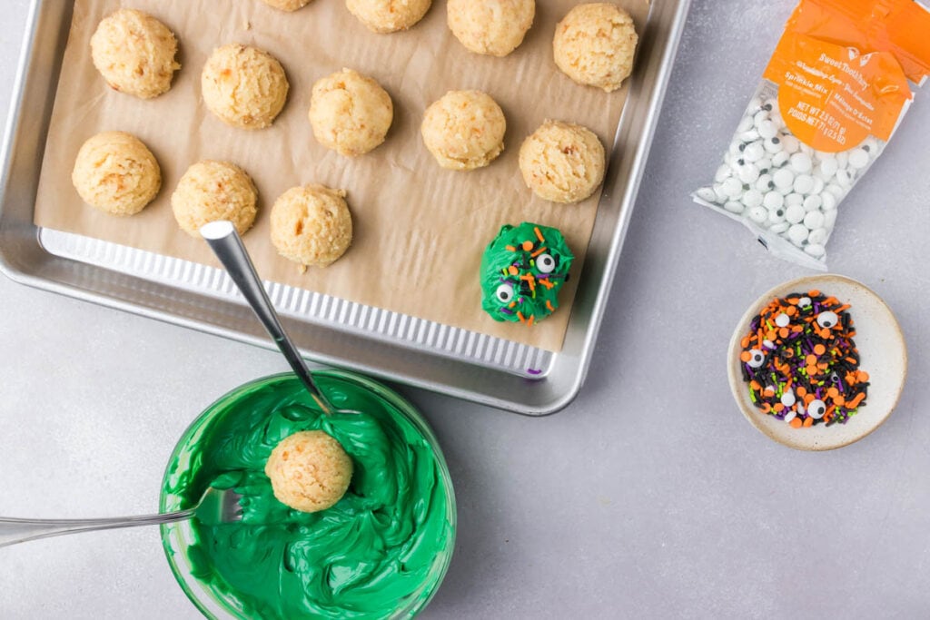 dunking the cake balls into the candy melts