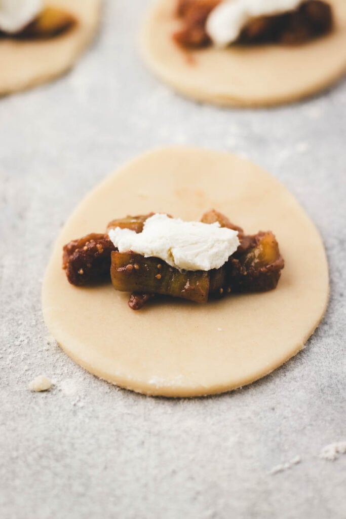 layering in the filling into the empanadas 