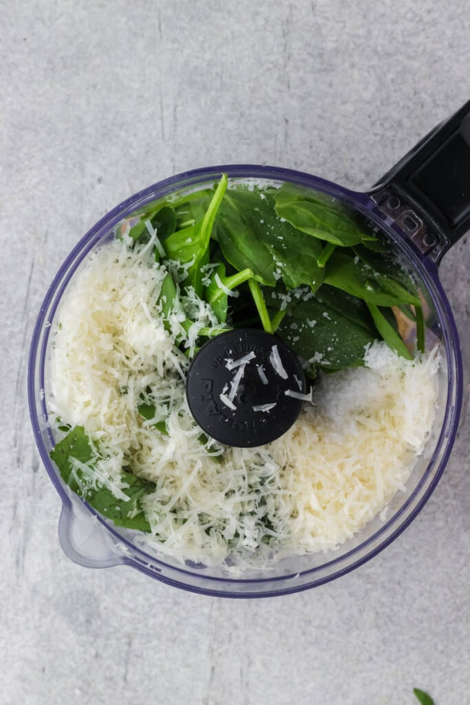 Ingredients for pesto in a food processor.