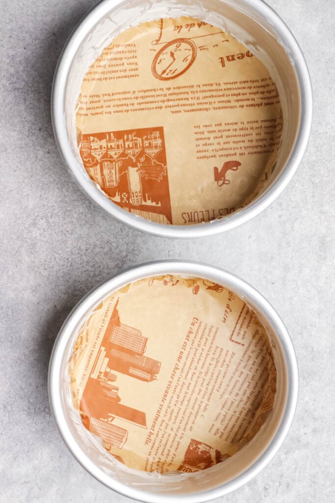 Lined cake pans with parchment paper.