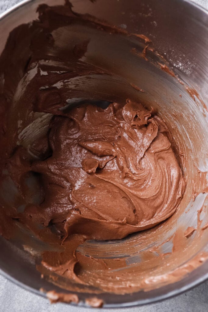 Cake batter in a kitchen aid mixing bowl.