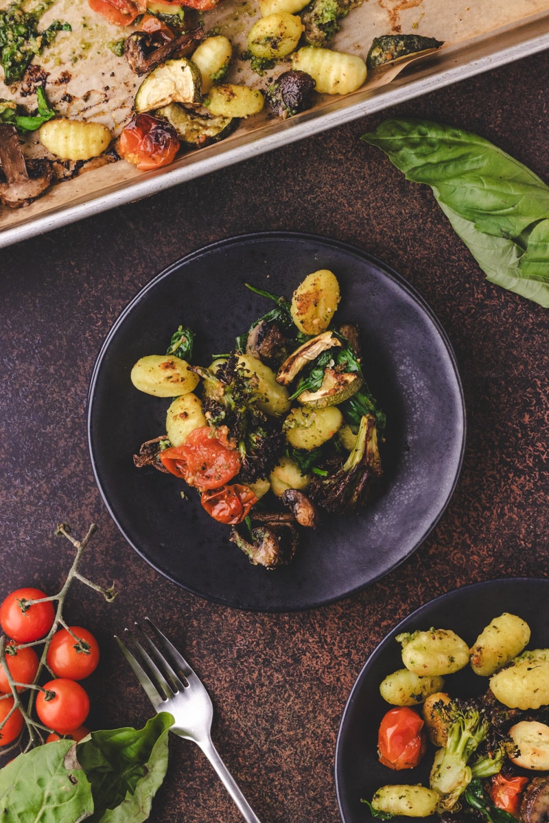plate of gnocchi with pesto and vegetables.