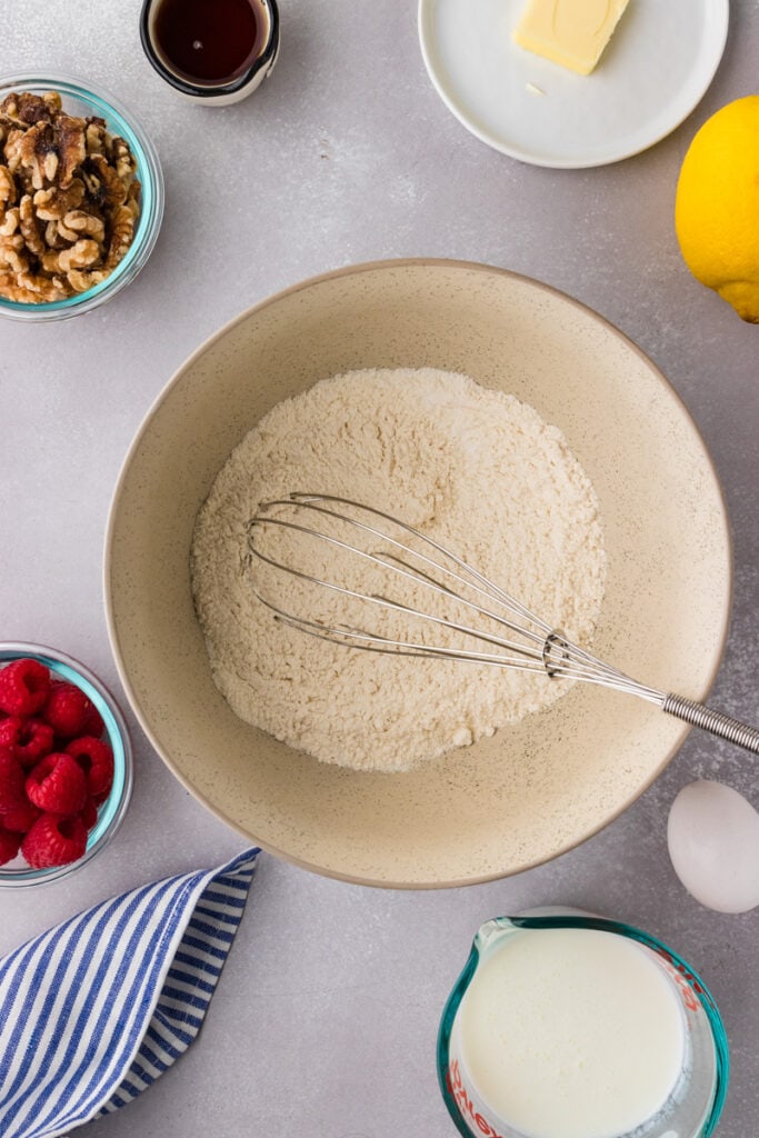 dry ingredients for pancakes in a large mixing bowl with a whisk.