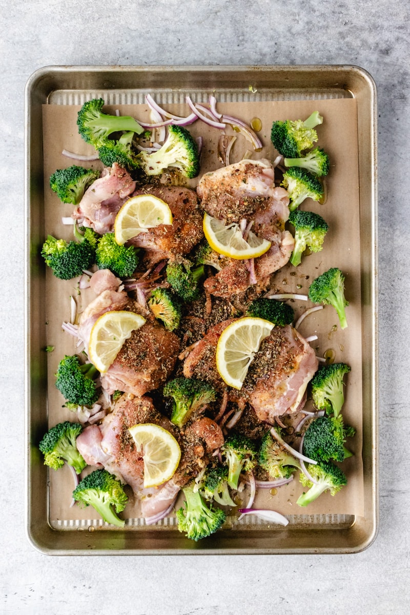 Preparing Whole30 Sheet Pan Chicken Thighs with Broccoli.