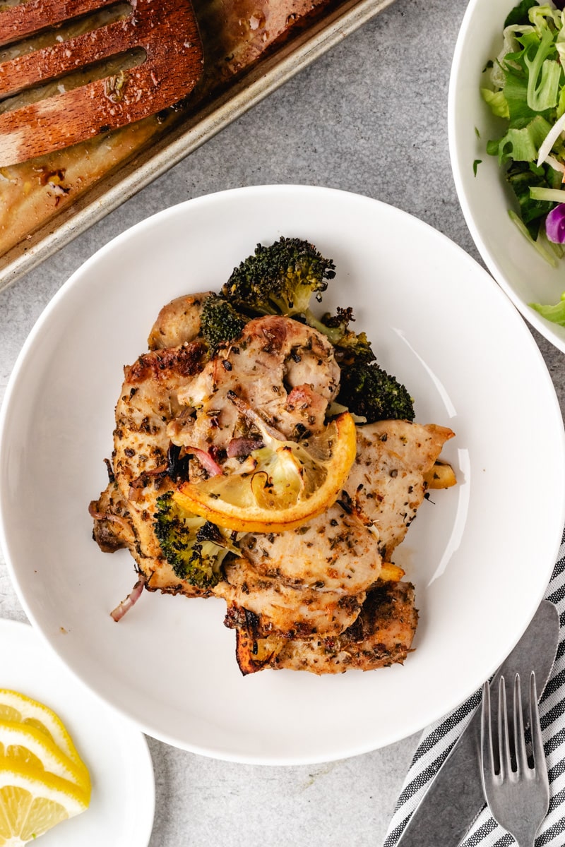 Whole30 Sheet Pan Chicken Thighs with Broccoli in a white bowl.