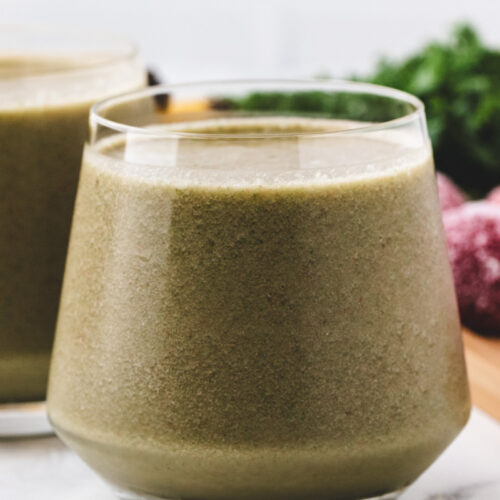 close up shot of strawberry banana kale smoothie.