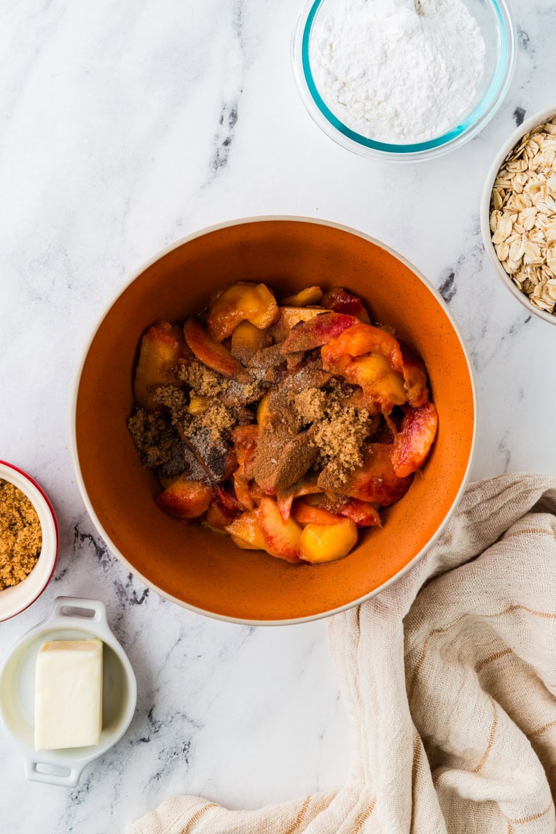 mixing peaches with spices.