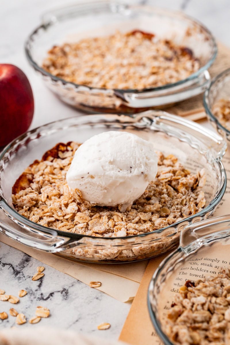 peach crisp with vegan vanilla ice cream on top.