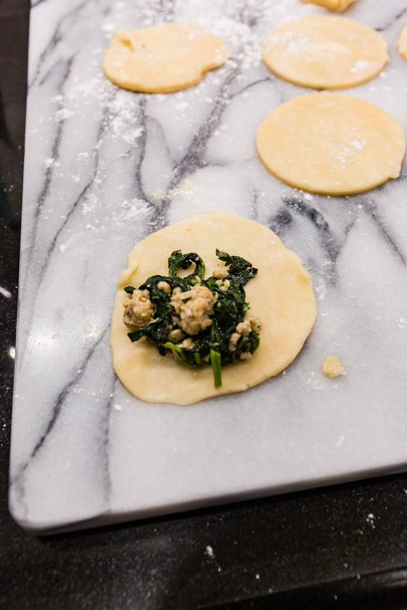 adding empanada filling