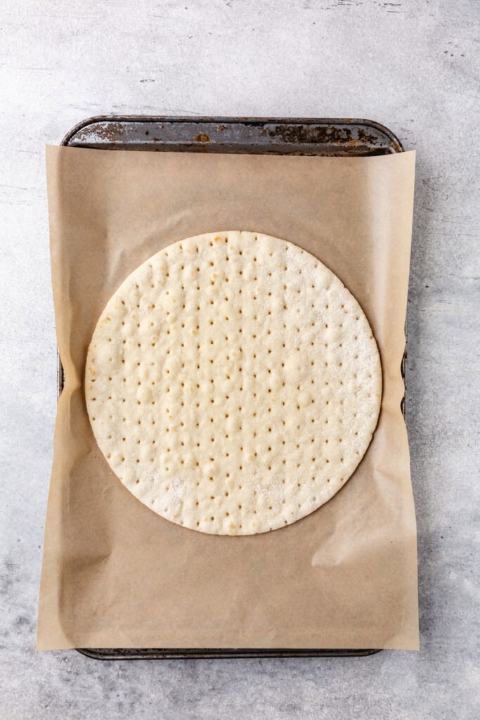 cauliflower pizza crust on parchment paper.