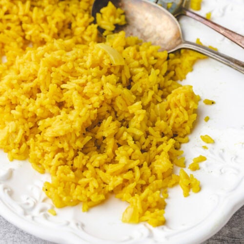 garlic turmeric rice on a white serving dish