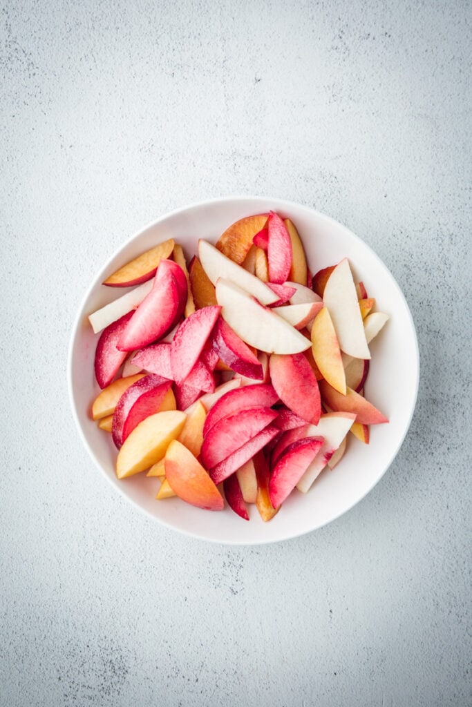 sliced fruits in a bowl.