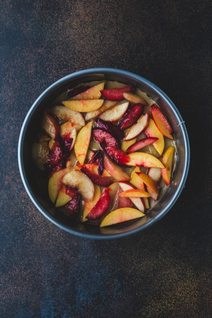 mix of stone fruits in the cake pan.
