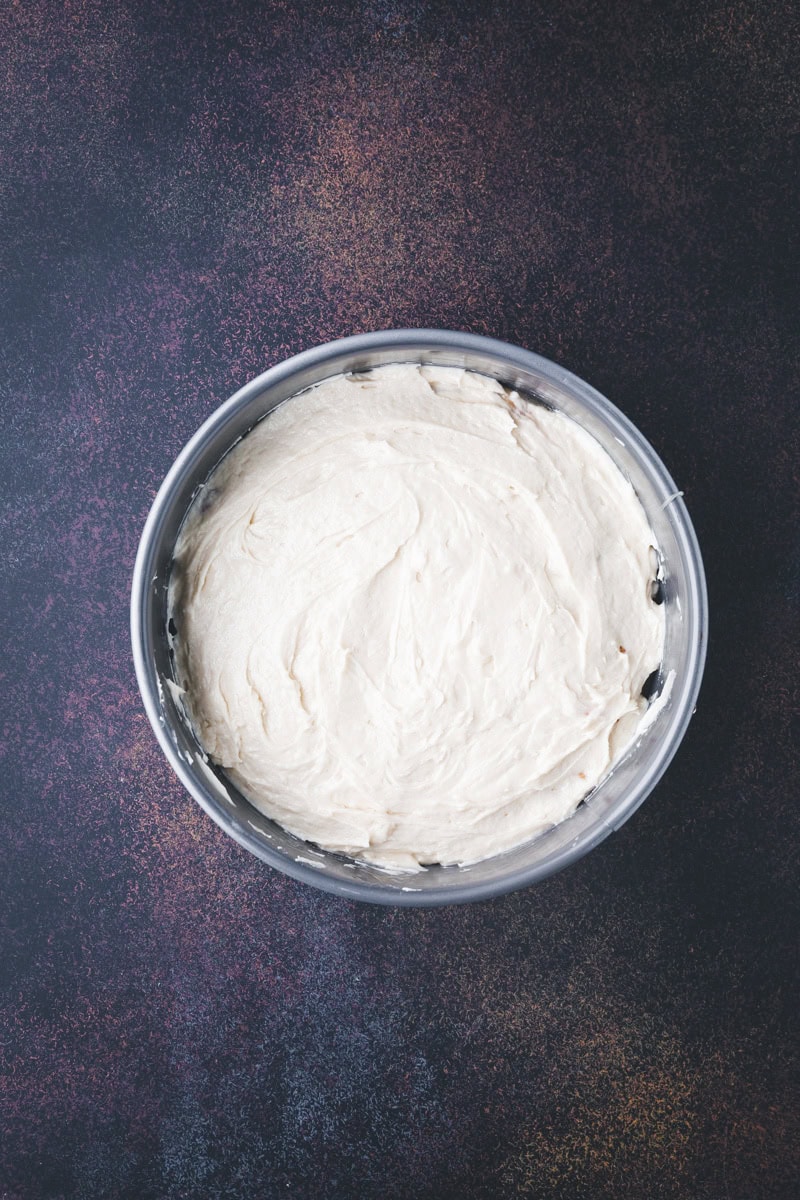 cake batter on top of the fruit in the cake pan.