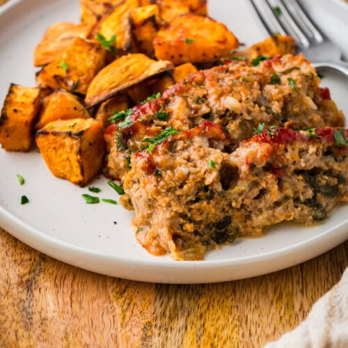 gluten free turkey meatloaf on a plate with sweet potatoes.