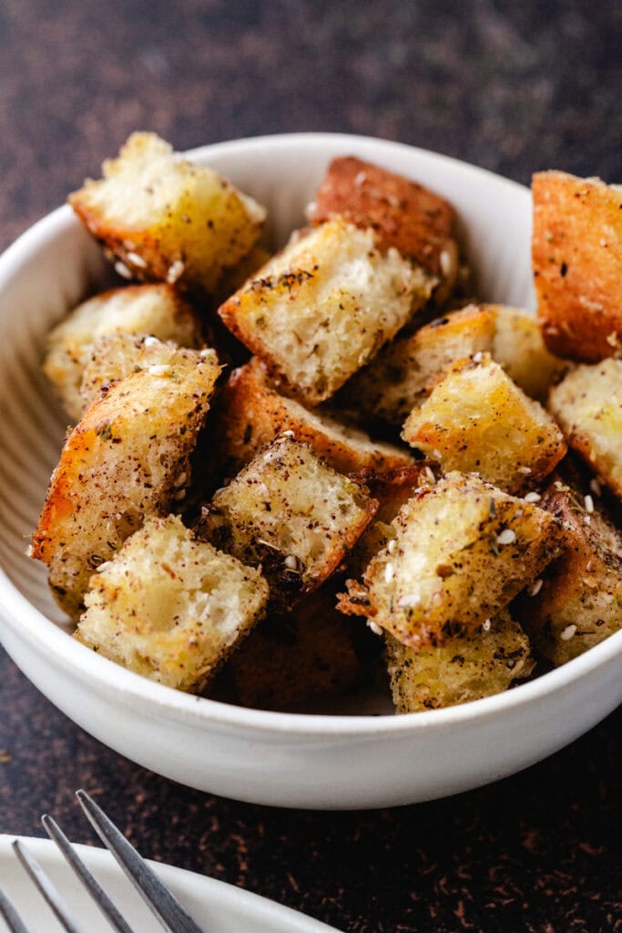 close up of za'atar croutons in bowl.