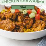 A white bowl brimming with a delicious Chicken Shawarma Bowl, garnished with diced tomatoes and cucumbers, rests invitingly on the table. The text above reads, Easy and Simple Chicken Shawarma Bowl.