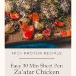 Sheet pan with cooked za’atar chicken thighs, red bell peppers, and potatoes, garnished with herbs. Text overlay promotes a 30-minute, high-protein za’atar chicken sheet pan dinner recipe.