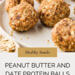 A plate of homemade peanut butter and date protein balls sits on a light surface, with a jar of peanut butter and oats in the background. Text reads: Healthy Snacks—packed with delicious peanut butter and date protein balls.