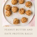 A white plate with nine peanut butter and date protein balls sits on a pink surface. Text below reads: “Peanut Butter and Date Protein Balls – Protein Snacks.” Discover the recipe at www.whensaltyandsweetunite.com.