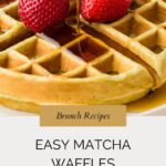 Close-up of syrup being poured onto golden matcha waffles, topped with two fresh strawberries. Text below reads: “Brunch Recipes. Easy Matcha Waffles. whensaltyandsweetunite.com.”.