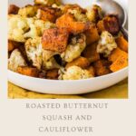 A white bowl filled with roasted butternut squash and cauliflower, seasoned with spices. A silver spoon rests in the bowl. Text below reads: “Roasted butternut squash and cauliflower. Easy winter meals.”.