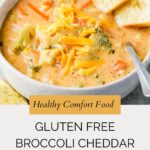 A bowl of creamy gluten free broccoli cheddar soup topped with shredded cheese, served with two slices of toasted bread. The text reads: “Healthy Comfort Food. Gluten Free Broccoli Cheddar Soup. whensaltyandsweetunite.com.”.