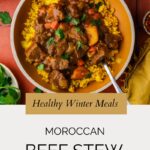 A bowl of Moroccan beef stew with chunks of beef, carrots, and potatoes served over yellow rice, garnished with parsley. Text reads: “Healthy Winter Meals: Moroccan Beef Stew.” Website: whensaltyandsweetunite.com.
