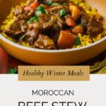 A bowl of Moroccan beef stew with chunks of beef, carrots, and spices served over yellow rice, garnished with cilantro. Text overlay reads: Healthy Winter Meals - Moroccan Beef Stew.