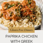 A plate of paprika chicken with spinach in a creamy Greek yogurt sauce served over brown rice, with a fork on the side. Text on the image reads: Gluten Free Dinners featuring delicious paprika chicken with Greek yogurt.