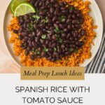 A plate of Spanish rice with tomato sauce topped with black beans, garnished with lime slices and cilantro, sits on a beige tablecloth. Text reads, Meal Prep Lunch Ideas: Spanish Rice with Tomato Sauce (No Bouillon).