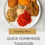 A white plate with piles of various ground spices in red, brown, orange, and tan sits on a gray surface, showcasing a vibrant tandoori spice mix. Text below reads, “Quick Homemade Tandoori Spice Mix.”.