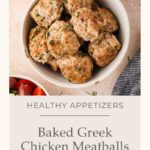 A bowl of Greek Chicken Meatballs sits on a light surface, surrounded by small dishes of sauce and vegetables. Text reads: Healthy Appetizers - Baked Greek Chicken Meatballs.