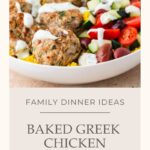A bowl of baked Greek Chicken Meatballs with savory sauce, surrounded by fresh tomatoes, crisp cucumbers, briny olives, and fluffy yellow rice. Text reads: Family Dinner Ideas, Baked Greek Chicken Meatballs.